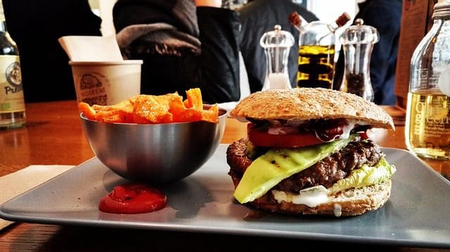 hamburger and fries on a plate in a restaurant